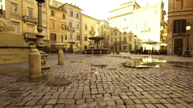 sunlit puddles pattern across cobblestone reflecting facades and windows, visual study of texture, rhythm and geometry in historic urban landscape