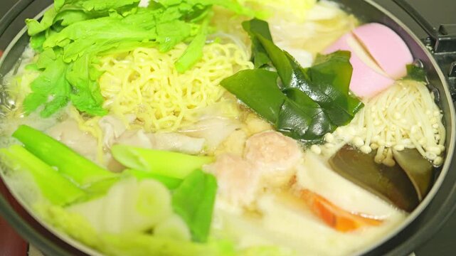 Colorful Japanese Hot Pot Simmering with Various Ingredients for a Warm Winter Meal