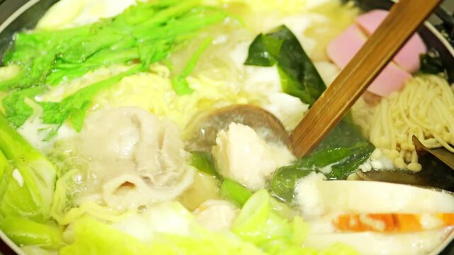 Colorful Japanese Hot Pot Simmering with Various Ingredients for a Warm Winter Meal