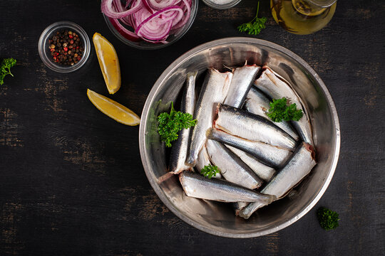Top View of Raw Sardines with Lemon and Red Onion. Flat lay