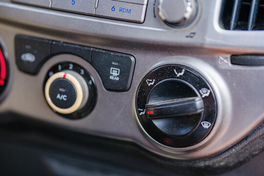 Car heating and ventilation control panel showing air conditioning switch airflow distribution dial and rear defroster button