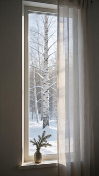 Minimal Nordic window with sheer curtain and evergreen sprig