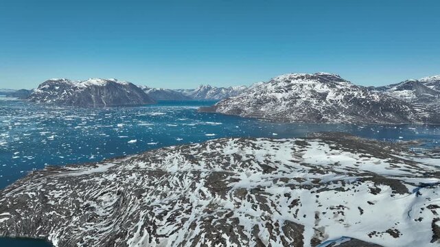 Aerial High Altitude Panoramic View of Greenland Arctic Fjord System with Snow Mountains and Ice