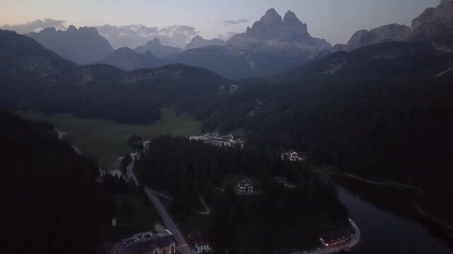 Aerial Drone View of Dolomites Mountain Valley at Dusk with Tre Cime di Lavaredo in Background