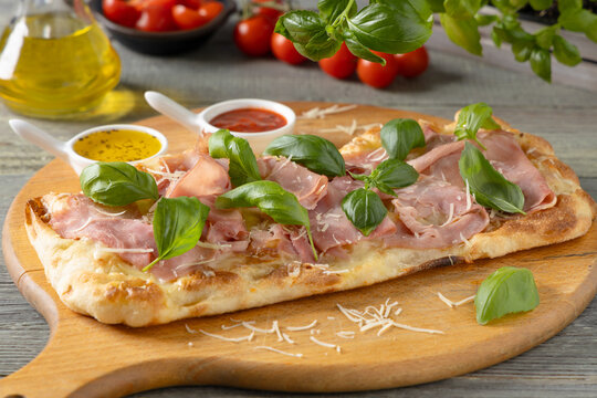 Traditional Roman pinsa with ham and basil.