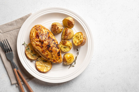 Oven roasted lemon garlic chicken and potatoes on plate