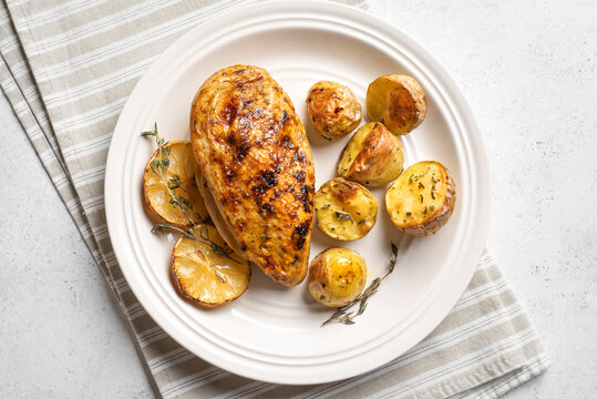 Oven roasted lemon garlic chicken and potatoes on plate