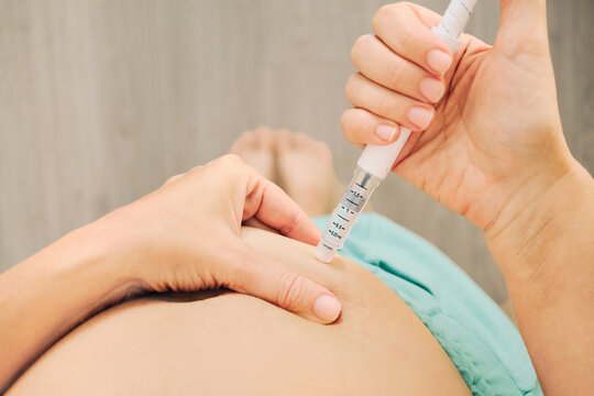 Woman self-administering GLP-1 injection into abdomen, weight loss therapy at home