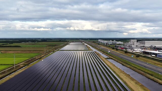 Aerial view of solar panels beside a highway and industry in Heerenveen