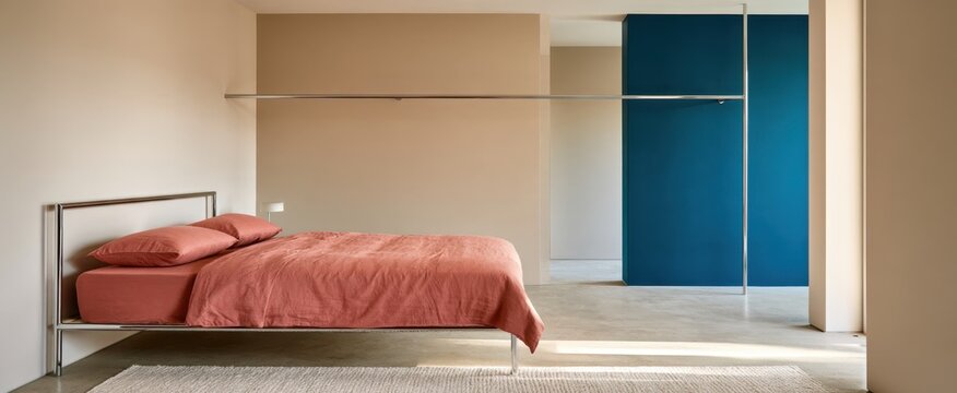 Minimalist bedroom interior with terracotta bedding and teal accent wall for interior design, decor and background