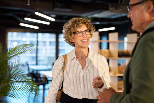 Happy business people discussing in modern office