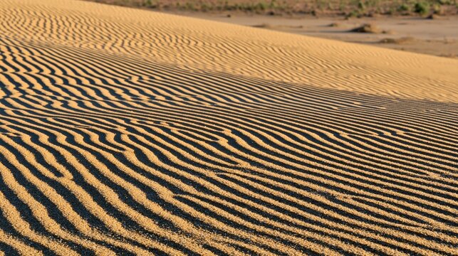 Sand dunes with rippled texture and shadows