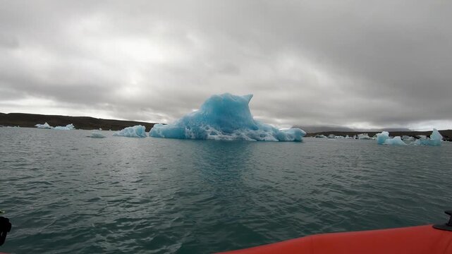 Boat trip cruise among melting icebergs as result of global warming. Jokulsarlon, Iceland