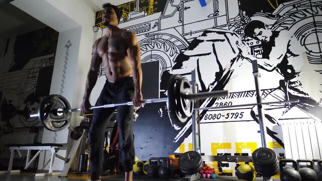 Athletic black man doing deadlift with heavy barbell at modern gym. Muscular african guy doing weightlifting exercises at sport club. Young afro american sportsman working out at fitness centre