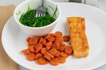 baked salmon  with seaweed salad and carrots © dmiller324