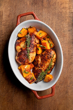 Autumn meal: roasted chicken breast and pumpkin with herbs