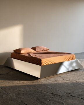 Sunlit minimalist bedroom with terracotta bedding on a low platform bed for interior design background and lifestyle editorial use