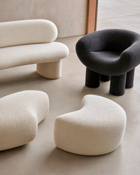 Modern boucle furniture set with cream sofa and black sculptural chair for interior design catalog and showroom styling