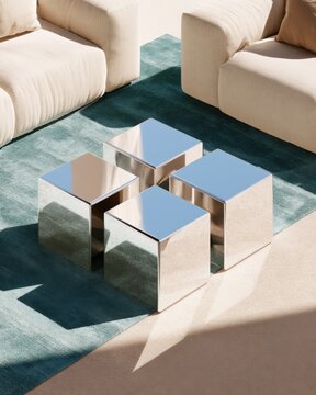 Contemporary minimalist living room interior with cream sofa and reflective chrome cube side tables on teal rug for design poster and background