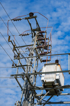 Vertical view of a distribution transformer and porcelain insulators
