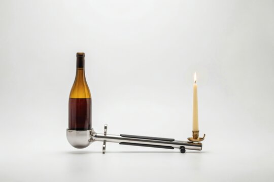 Sommelier's decanting cradle with a candle for sediment