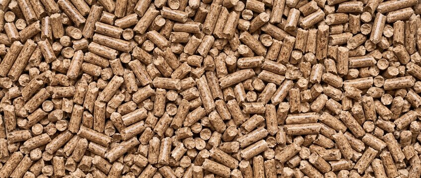 Compressed wood pellets texture background. Close-up full frame view of biofuel pellet material for heating