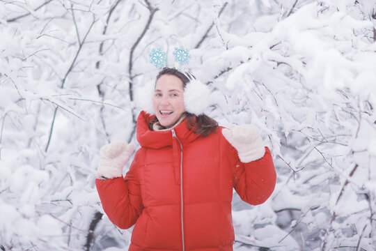 Joyful Woman in Red Winter Jacket Enjoying Snowy Wonderland