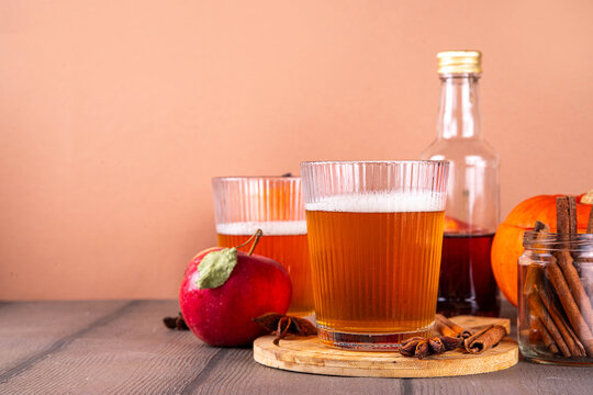 Homemade Hard Pumpkin Apple Cider with Warm Fall Spices, Tasty Alcohol or non-alcoholic cocktail for fall seasonal party, fruit beer drink 