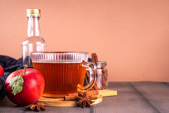 Sweet autumn apple spice tea, warm autumn drink with black tea, fall spices - cinnamon, nutmeg, ginger, cloves, tasty cozy warming beverage