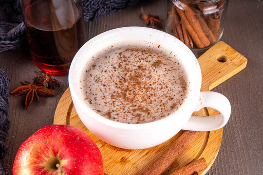 Sweet autumn apple spice coffee latte, warm autumn drink with strong coffee, creamer, fall spices - cinnamon, nutmeg, ginger, cloves, tasty cozy warming beverage