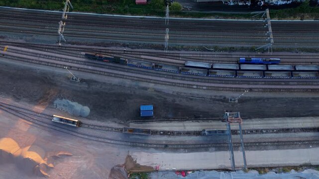 Aerial view of Wellingborough sidings railway yard with freight trains on tracks during sunset in Wellingborough, England, United Kingdom.