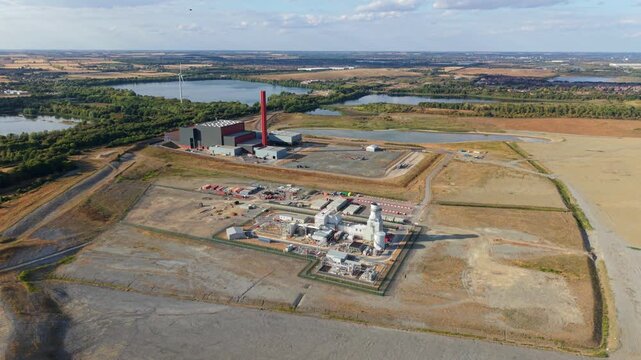 Aerial view of the Rookery South ERF and Millbrook Power plant facilities surrounded by open fields and lakes in Stewartby, England, United Kingdom.