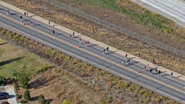 Aerial view of a group of people participating in a road race along a paved street in Boulder, Colorado, United States.