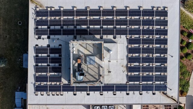 Aerial view of solar panels installed on a flat commercial rooftop in Boulder, Colorado, United States.