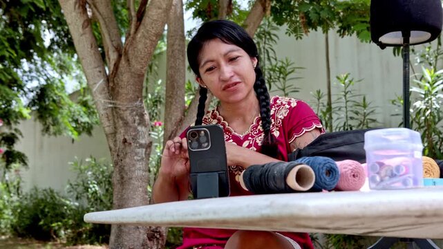 Smiling latina artisan teaching macrame weaving online