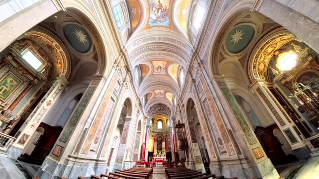 Interior of the Cathedral of Santa Maria Assunta in Sutri, Italy, featuring the baroque high altar with red drapery, decorated vault frescoes, and grand columns under the dome