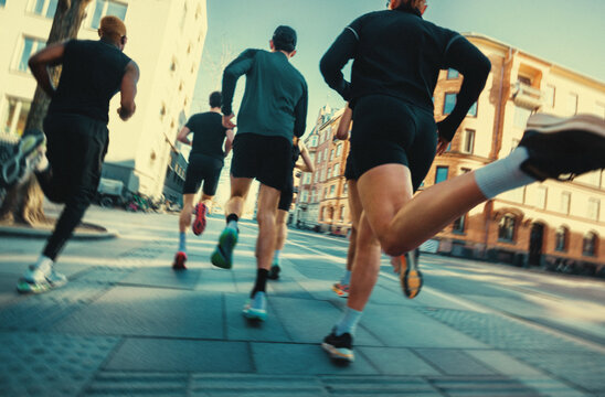 Team running through the city highlights fitness and run club culture