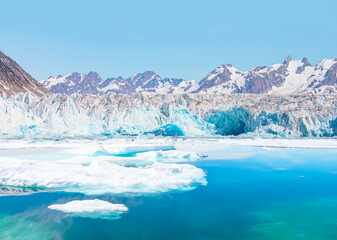 Melting icebergs by the coast of Greenland, on a beautiful summer day - Melting of a iceberg and pouring water into the sea - Greenland © muratart