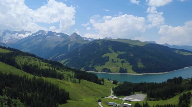 Aerial Pan View of Koenigsleiten Village and Alpine Landscape with Lake and Mountains
