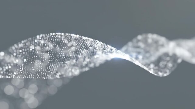 Tiny bubbles form and move in a wavy pattern against a gray background. The light reflects off the bubbles, creating a dynamic look
