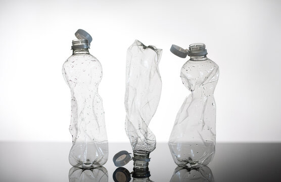 Minimalistic concept of crumpled PET bottles with bottom reflection