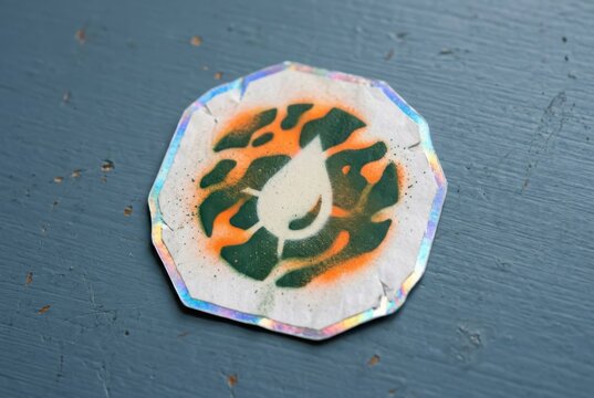 Holographic Sticker on Blue Painted Wood Surface