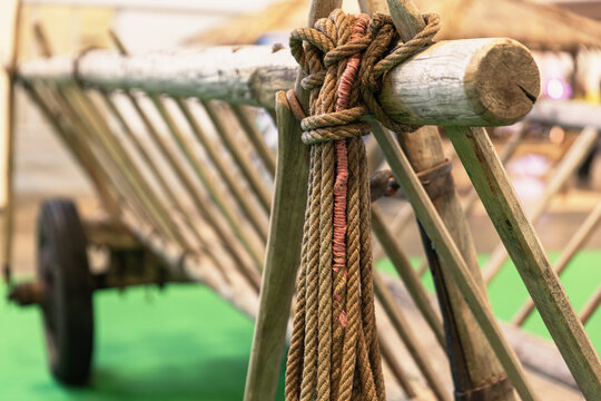 Close-Up Of Wooden Cart With Rope Knot Rustic Transportation Equipment For Agriculture And Farming Traditional Vehicle With Wheel And Bamboo Frame