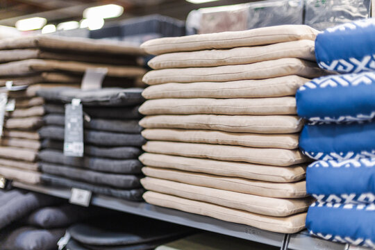 Stacked Cushions and Pillows on Retail Store Shelving