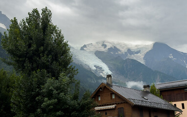 Obraz premium Summer view of the Mont Blanc massif above forested slopes 