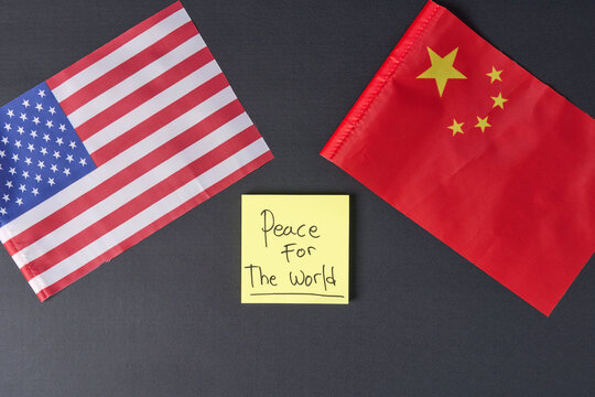 USA and China national flags with Peace For The World text on yellow note concept for international diplomacy and global peace