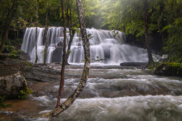 The beauty of Pang Sida Waterfall with water cascading across the entire width of the falls at Pang Sida National Park, Sa Kaeo Province, Thailand. © VespaFoto