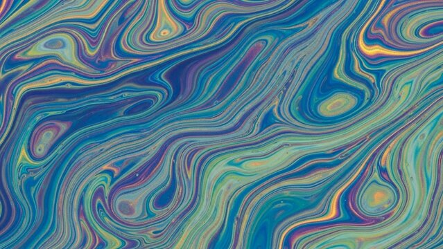 Abstract liquid swirls in vibrant blue and gold tones