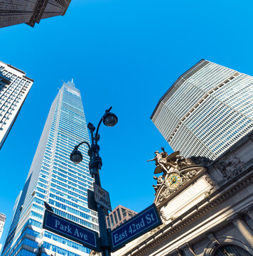 Manhattan skyscrapers viewed from below under a blue sky
