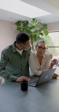Senior Couple Collaborating on a Laptop
